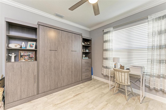 home office with light hardwood / wood-style flooring, ornamental molding, and ceiling fan