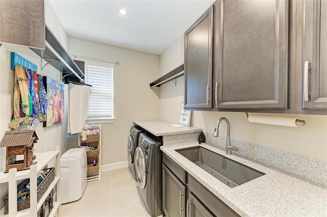 laundry room featuring cabinets, independent washer and dryer, light tile patterned flooring, and sink