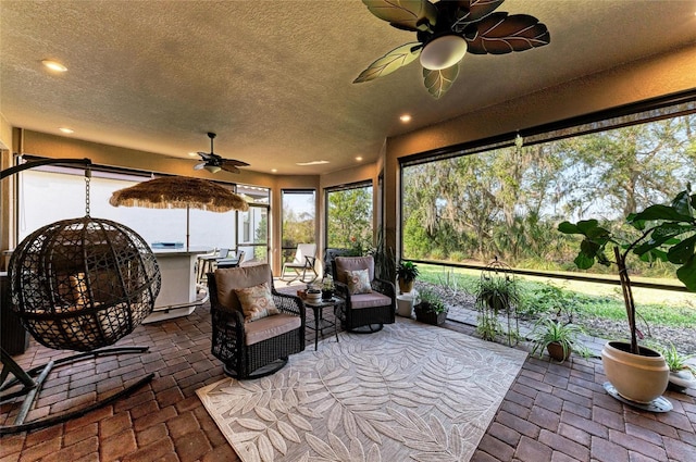 sunroom with ceiling fan