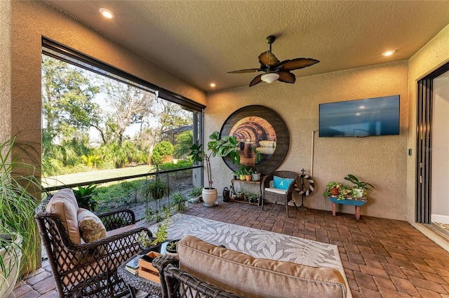 sunroom / solarium with ceiling fan