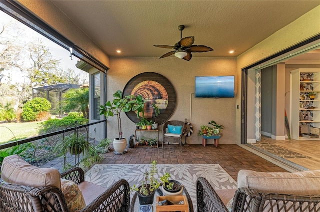 sunroom featuring ceiling fan