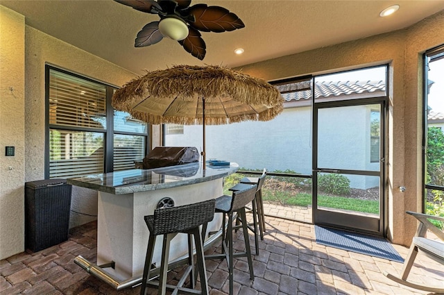 sunroom / solarium with ceiling fan