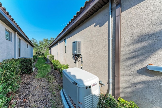 view of side of home with central air condition unit