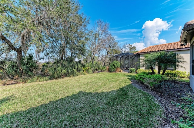 view of yard featuring glass enclosure