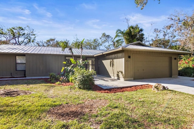 ranch-style home featuring a garage and a front lawn