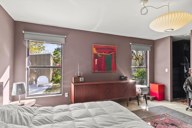 tiled bedroom with multiple windows