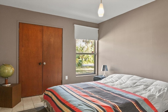 tiled bedroom featuring a closet