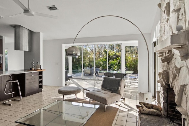 tiled living room with ceiling fan