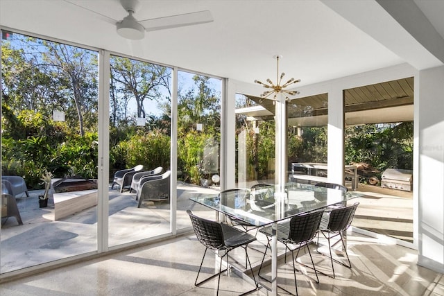 sunroom / solarium with a notable chandelier