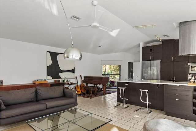 tiled living room with lofted ceiling, sink, and ceiling fan