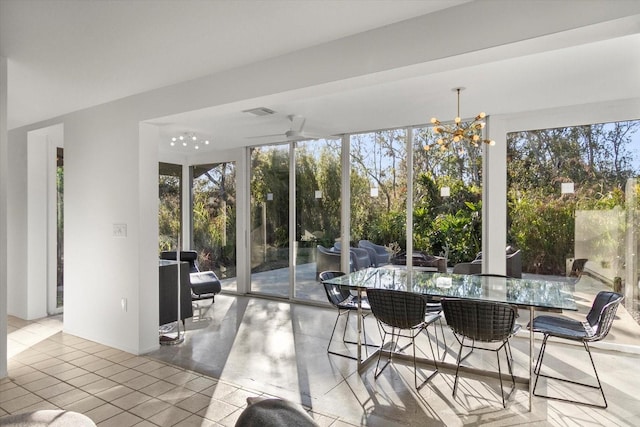 sunroom / solarium with an inviting chandelier