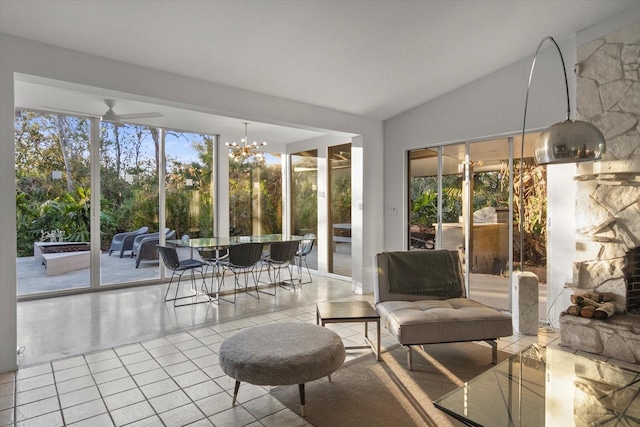 sunroom / solarium featuring lofted ceiling and a chandelier