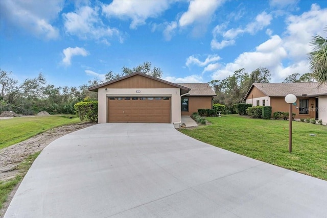 view of front of property with a garage, driveway, and a front yard