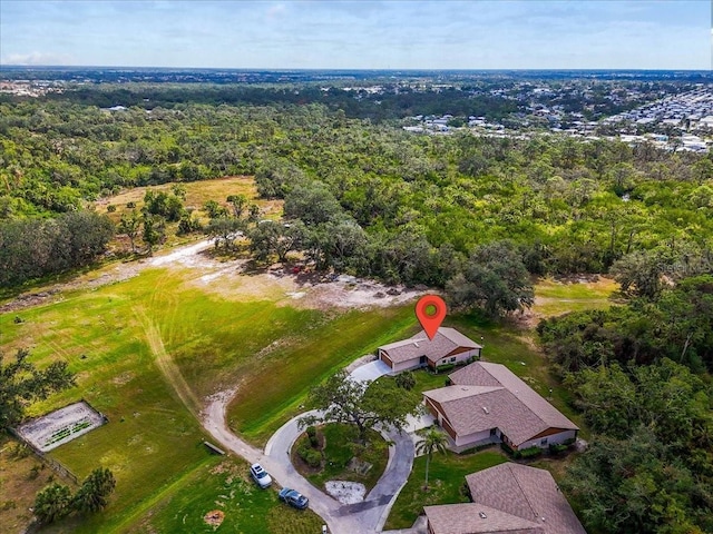 birds eye view of property featuring a wooded view