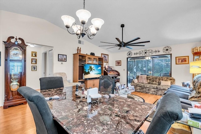 dining space with light wood-style floors, visible vents, vaulted ceiling, and ceiling fan with notable chandelier