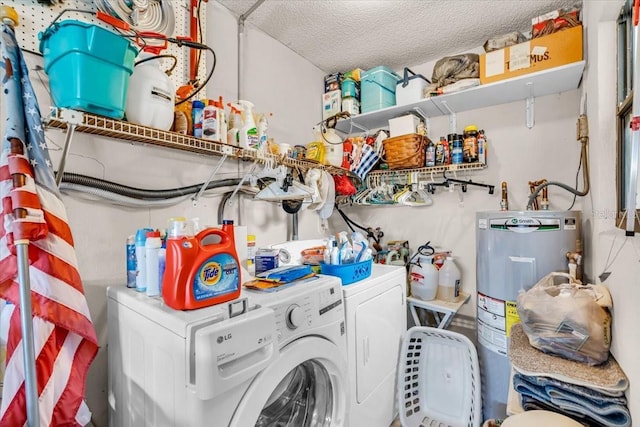 clothes washing area featuring laundry area, electric water heater, a textured ceiling, and separate washer and dryer