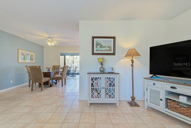 tiled living room featuring ceiling fan