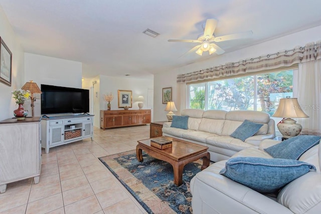 tiled living room with ceiling fan