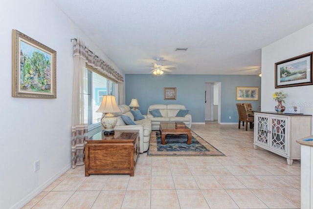 tiled living room featuring ceiling fan