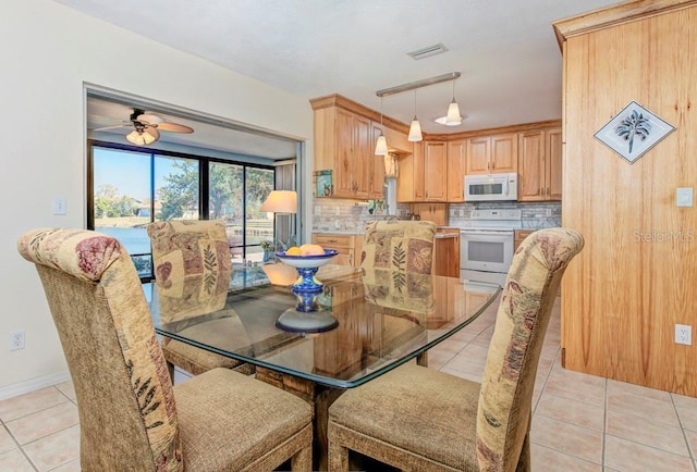 tiled dining area featuring ceiling fan