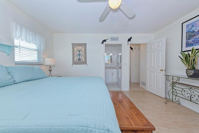 bedroom with ceiling fan, ensuite bath, and light hardwood / wood-style floors