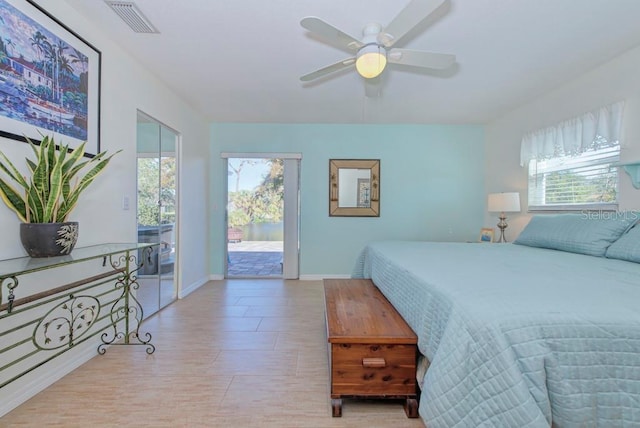 bedroom featuring ceiling fan, light hardwood / wood-style floors, multiple windows, and access to outside