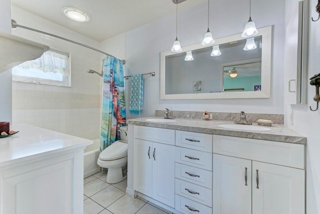 full bathroom featuring tile patterned flooring, vanity, ceiling fan, toilet, and shower / bath combo with shower curtain