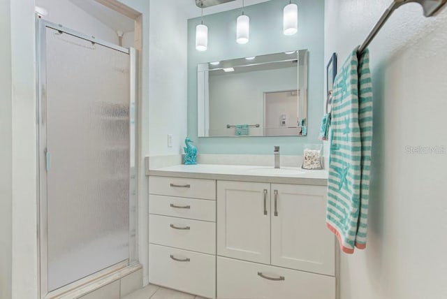 bathroom featuring vanity, tile patterned floors, and a shower with shower door