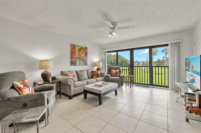 living room with light tile patterned flooring, a textured ceiling, and ceiling fan