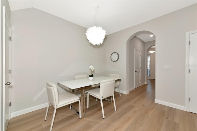 dining area with lofted ceiling and light hardwood / wood-style floors