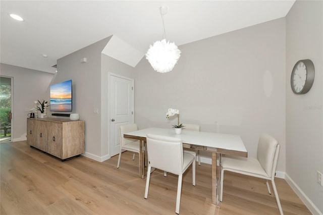 dining space with a notable chandelier and light wood-type flooring