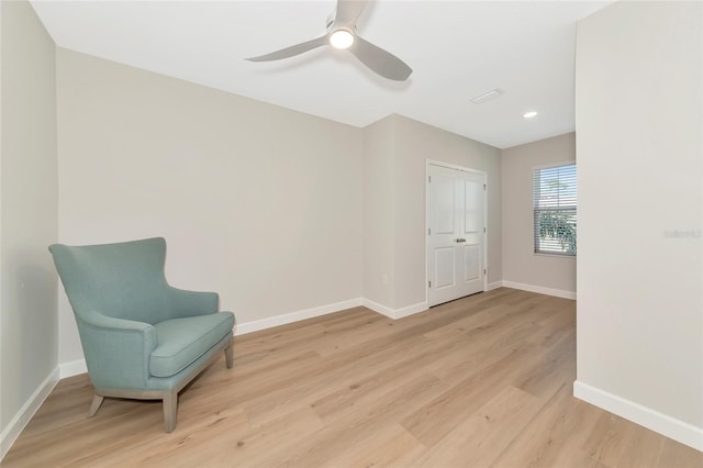 living area featuring ceiling fan and light hardwood / wood-style flooring