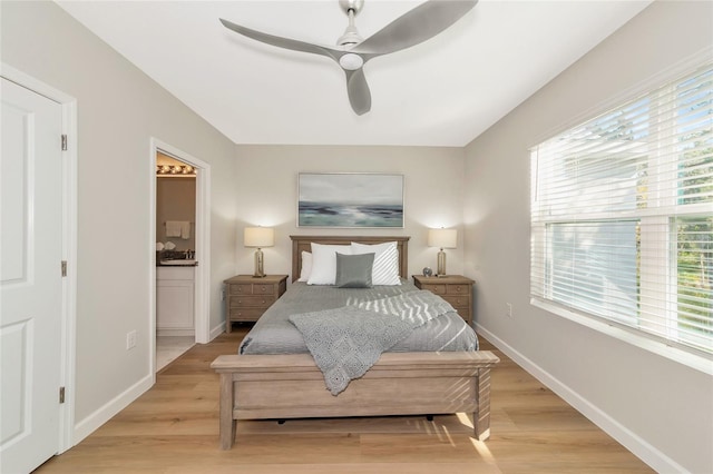 bedroom featuring ceiling fan, connected bathroom, and light hardwood / wood-style floors