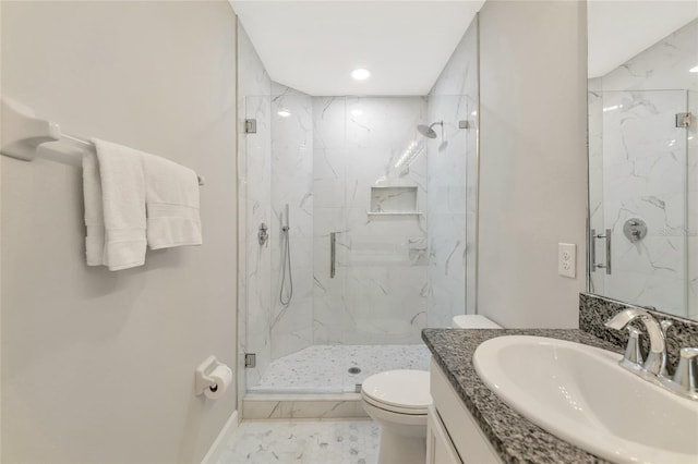 bathroom featuring vanity, toilet, and an enclosed shower