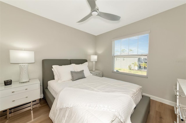 bedroom with light hardwood / wood-style floors and ceiling fan