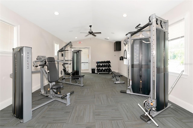 exercise room with dark colored carpet, lofted ceiling, a wealth of natural light, and ceiling fan