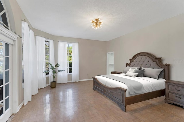 bedroom with light parquet flooring and a textured ceiling