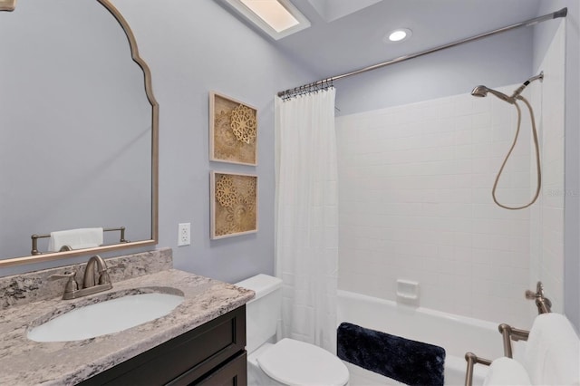 full bathroom featuring toilet, vanity, and shower / bathtub combination with curtain