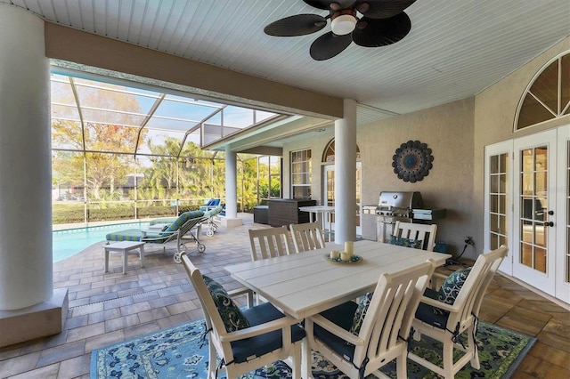 sunroom / solarium featuring ceiling fan and french doors