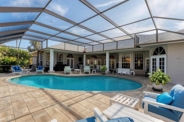 view of pool featuring a lanai, a patio area, french doors, and ceiling fan