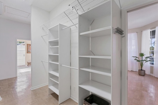 spacious closet with light parquet floors