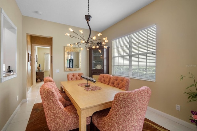 tiled dining area with a chandelier