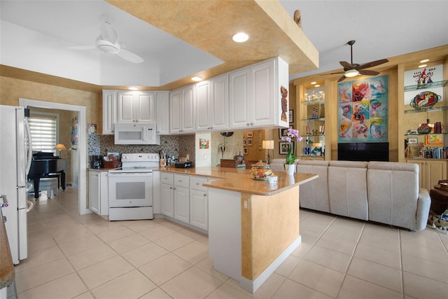 kitchen with white cabinetry, white appliances, kitchen peninsula, and ceiling fan