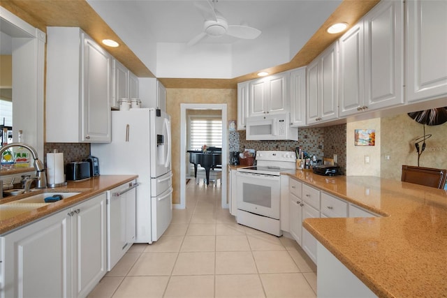 kitchen featuring sink, white appliances, ceiling fan, white cabinetry, and light stone counters