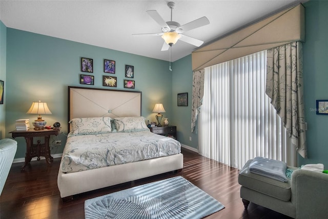 bedroom featuring multiple windows, dark wood-type flooring, and ceiling fan