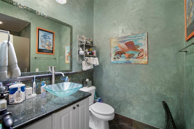 bathroom featuring vanity, backsplash, tile patterned floors, and toilet