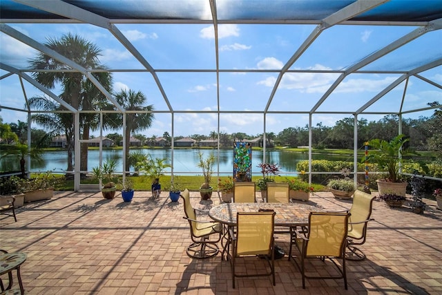 view of patio featuring a water view and a lanai