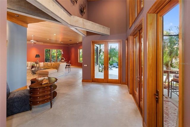 entryway with french doors, a towering ceiling, and a wealth of natural light