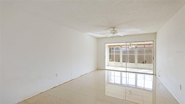 unfurnished room featuring light tile patterned floors, a textured ceiling, and ceiling fan