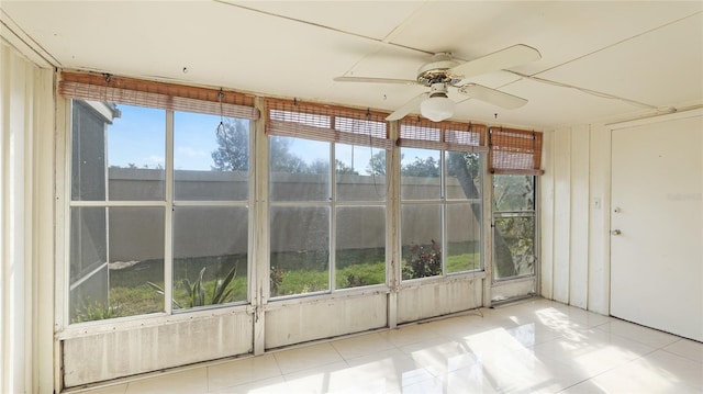 unfurnished sunroom featuring ceiling fan